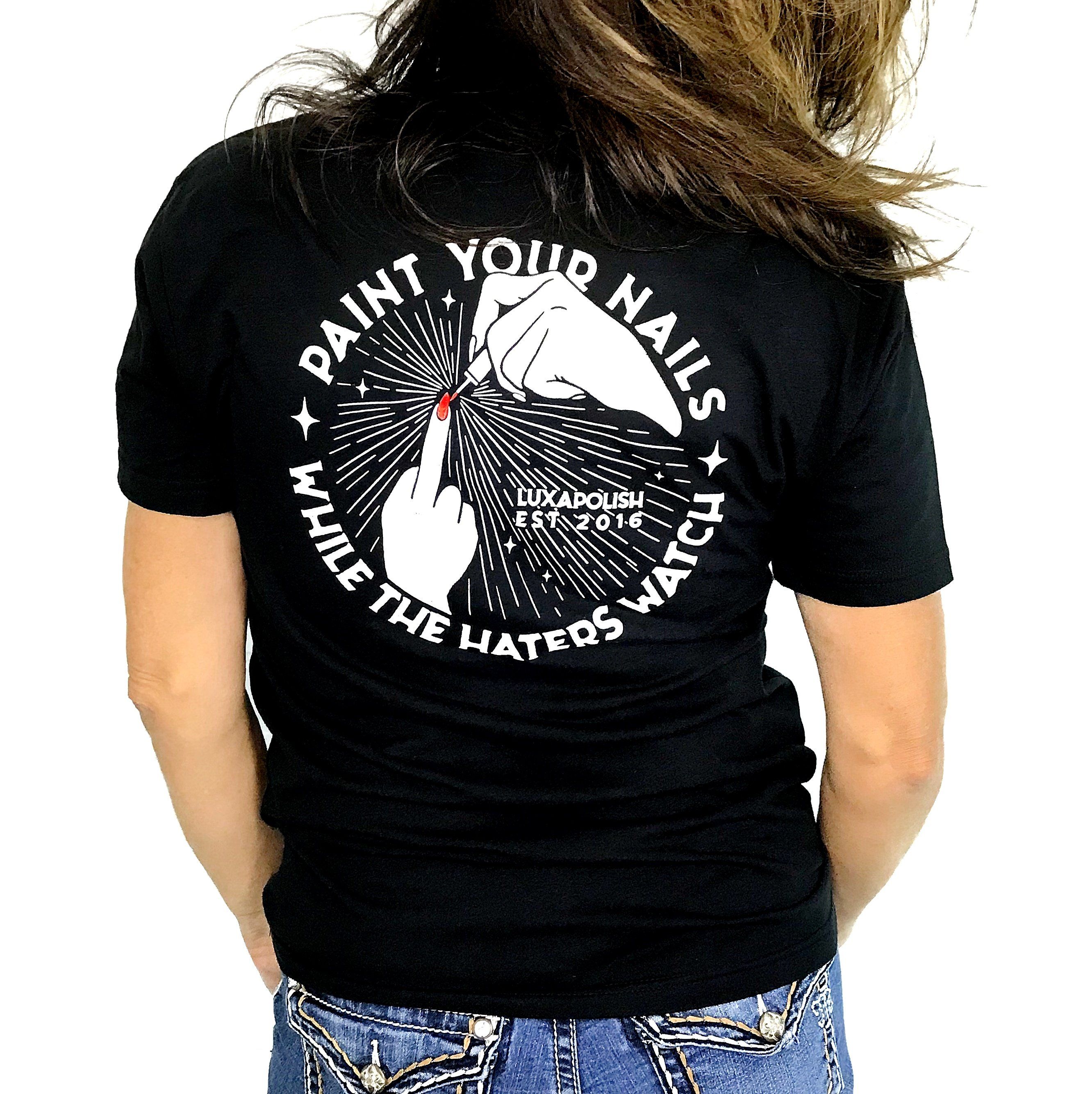Back view of HATERS tee with large white graphic reading Paint your nails while the haters watch and a red fingernail on black